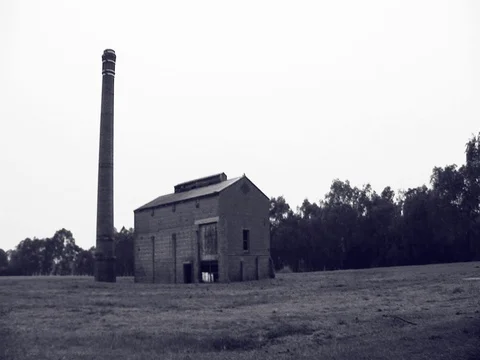 Black and White shot of an old abandoned building. Pan across the screen. Stock Footage 79905426