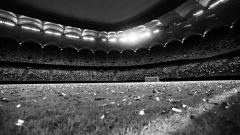 Black and white shots of a soccer stadium with glittering confetti on the lawn Stock Footage