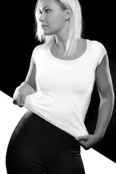 Black and white split portrait of woman standing in studio Stock Photos