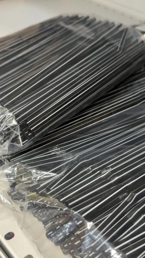 Black and white striped plastic drinking straws arranged for cocktails, cold Stock Footage 345172811