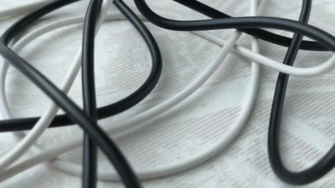 Black and white tangled cables, wires on the table at home close-up. The concept Stock Footage 316117844