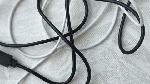 Black and white tangled cables, wires on the table at home close-up. The concept Stock Footage 316117975