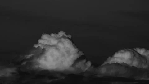 Black and White Time-Lapse of Majestic Cumulus Clouds Against a Dark Sky Stock Footage 318296004