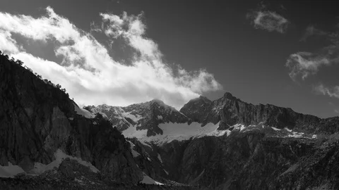 Black and white timelapse of clouds running on summits in the Pyrenees chain. Stock Footage 109627338