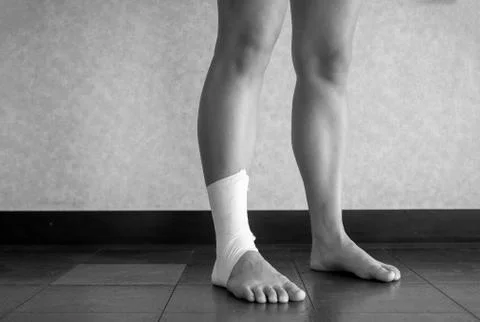 Black and white version of Athlete exercising with injured ankle Stock Photos
