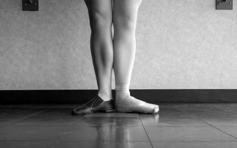 Black and white version of Dancer standing in parallel position at the barre Stock Photos