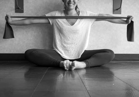 Black and white version of Smiling Young Active Female using a theraband Stock Photos