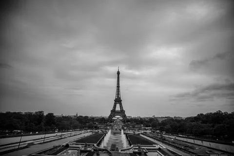 A black and white view of the Eiffel Tower in Paris, France with a cloudy sky Stock Photos