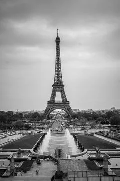 A black and white view of the Eiffel Tower in Paris, France with a long fountain Stock Photos
