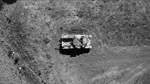 Black and white view of man sitting on a tank aerial rising drone 4k Stock Footage 170718096