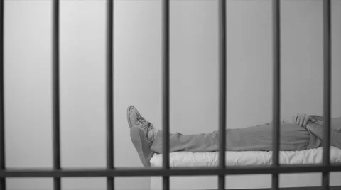 Black and white view of scene of an inmate sleeping in prison Stock Footage 60574411