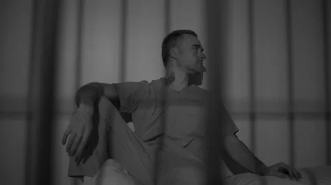 Black and white view of scene of a hardened criminal in jail Video stock 60574432