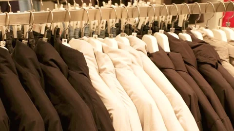 Black and white winter jackets hanging on hanger in a clothing store, side view. Stock Footage 289520293