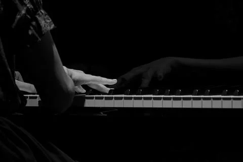 Black and white of woman hands playing on a piano Stock Photos