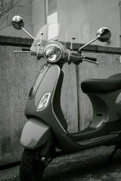 A black and withe shot of a bike parked on the sidewalk Stock Photos