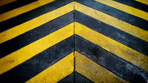 Black and yellow caution warning  patten background on the floor. Stock Photos