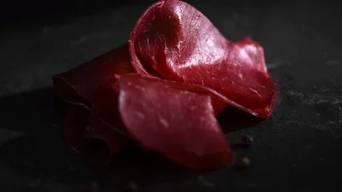 Black angus dried beef, slices of aged wagyu, delicatessen, snack on black Stock Footage 320370270