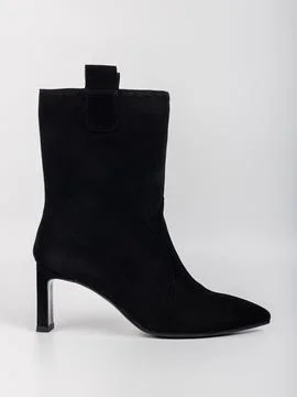 Black ankle boot on a light background showing the shape and design of the .. Stock Photos