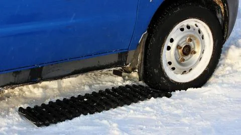 Black anti-slip mat of a rectangular shape is placed under the wheel of a ... Stock Photos