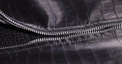 Black artificial fabric in the style of crocodile skin with specks and spots, a Video stock 327050995
