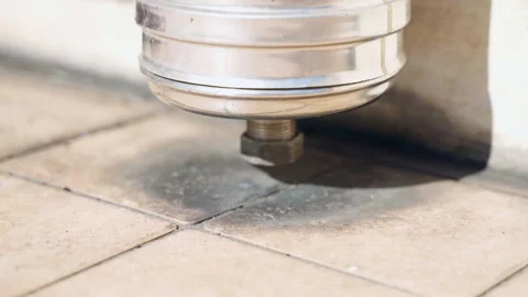 Black ash emission under the stainless pipe on the floor near the house, result Stock Footage 325528447