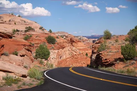 The black asphalt switchbacks surrounded by red rock walls crossing the Capit Stock Photos