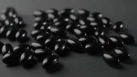 Black Astaxanthin Softgels Static Macro Video stock 332364323