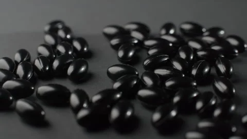 Black Astaxanthin Softgels Tracking Macro Shot Video stock 332364183