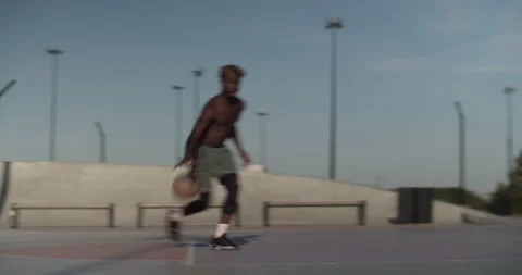 Black athlete doing freestyle tricks before throwing ball Stock Footage 213304863