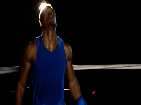 A black athlete shadowboxes/practices in an empty ring Stock Footage 83375739