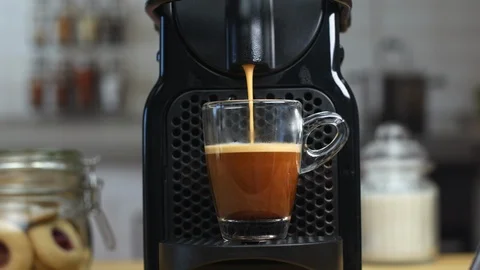 Black automated coffee maker making an espresso coffee at home or in a cafe. Stock-Footage 125082582