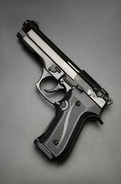 Black automatic gun on black background Stock Photos