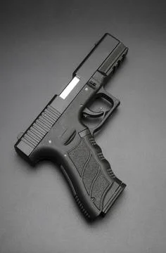 Black automatic gun on black background Stock Photos