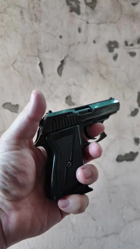 Black automatic pistol in hand. Man shoots from pistol. Concept weapon. Old.. Stock Footage 314382449