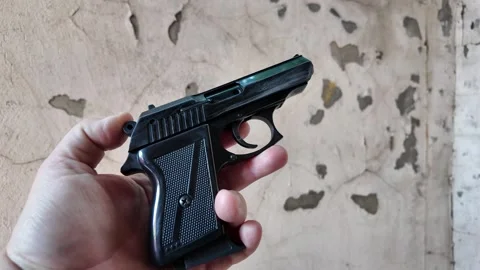 Black automatic pistol in hand. Man shoots from pistol. Concept weapon. Old.. Stock Footage 314382987