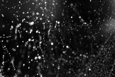 Black background with bokeh, spider web with water drops Stock Photos
