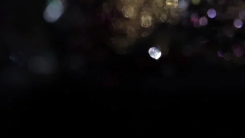 Black background with colored bokeh lights Vidéo 318580327