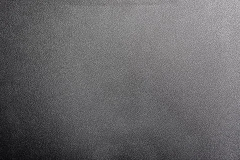 Black background created by a plastic rough surface Stock Photos