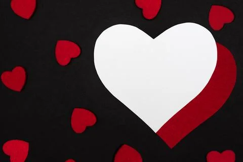 Black background decorated with small red hearts Stock Photos
