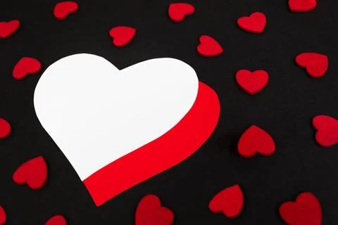 Black background decorated with small red hearts Stock Photos