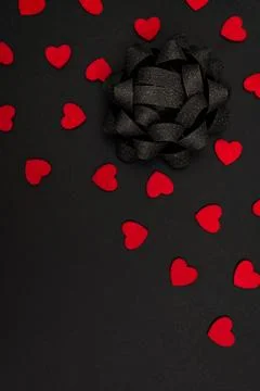 Black background decorated with small red hearts Stock Photos