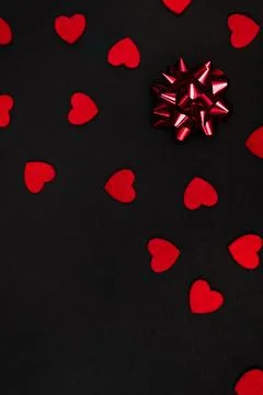 Black background decorated with small red hearts Stock Photos