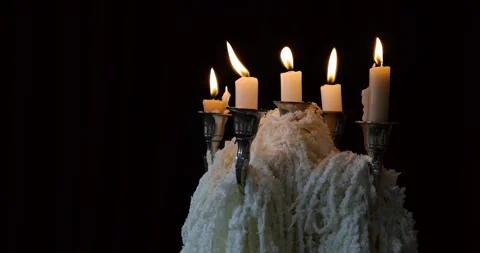 Black background with glowing candles in a sleek candleholder. Stock Footage 294040569