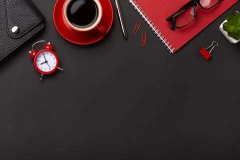 Black background red coffee cup notepad alarm clock flower diary scores keybo Stock Photos