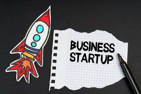 On a black background, a rocket, a marker and paper with the inscription - BU Stock Photos