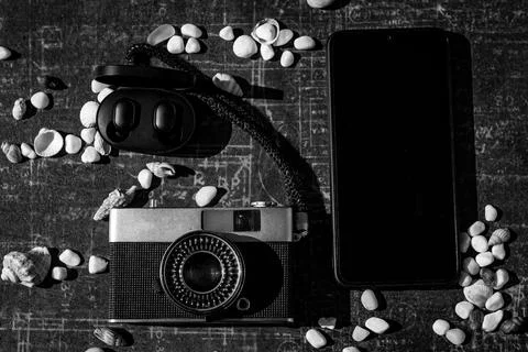 On a black background, a set of tourists: camera, mobile phone, headphones Stock Photos
