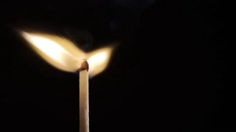 On a black background in a slow video a match lights up and burns Stock Footage 143540045