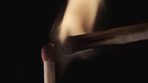 On a black background in a slow video a match lights up and burns Stock Footage 143540306