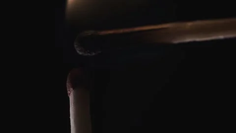 On a black background in a slow video a match lights up and burns Stock Footage 143540328