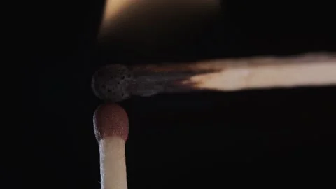 On a black background in a slow video a match lights up and burns Stock Footage 143540454